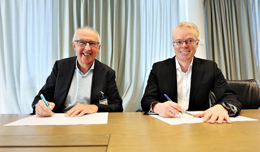 a couple of men sitting at a table with papers and pens a couple of men sitting at a table with papers and pens