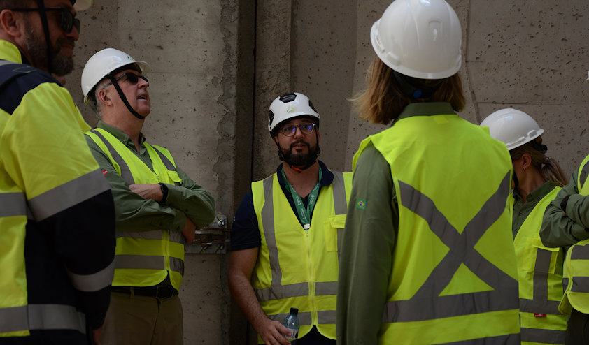 a group of people wearing hardhats and reflector vests a group of people wearing hardhats and reflector vests