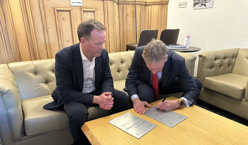 a person showing a person signing a partnership a person showing a person signing a partnership