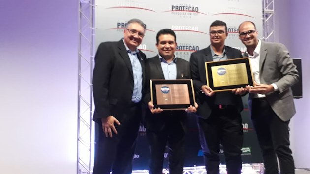 a group of men holding a plaque a group of men holding a plaque